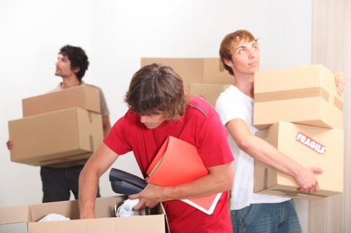 Trained movers handling furniture carefully in a Finsbury Park removal
